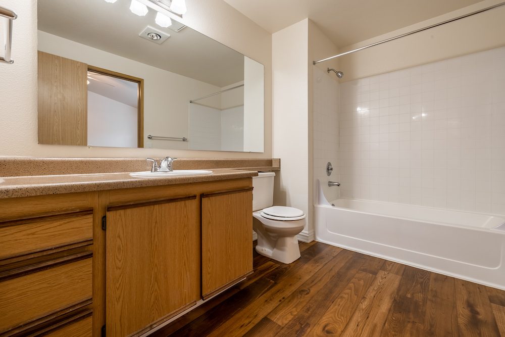 Full bathroom with vanity and tub